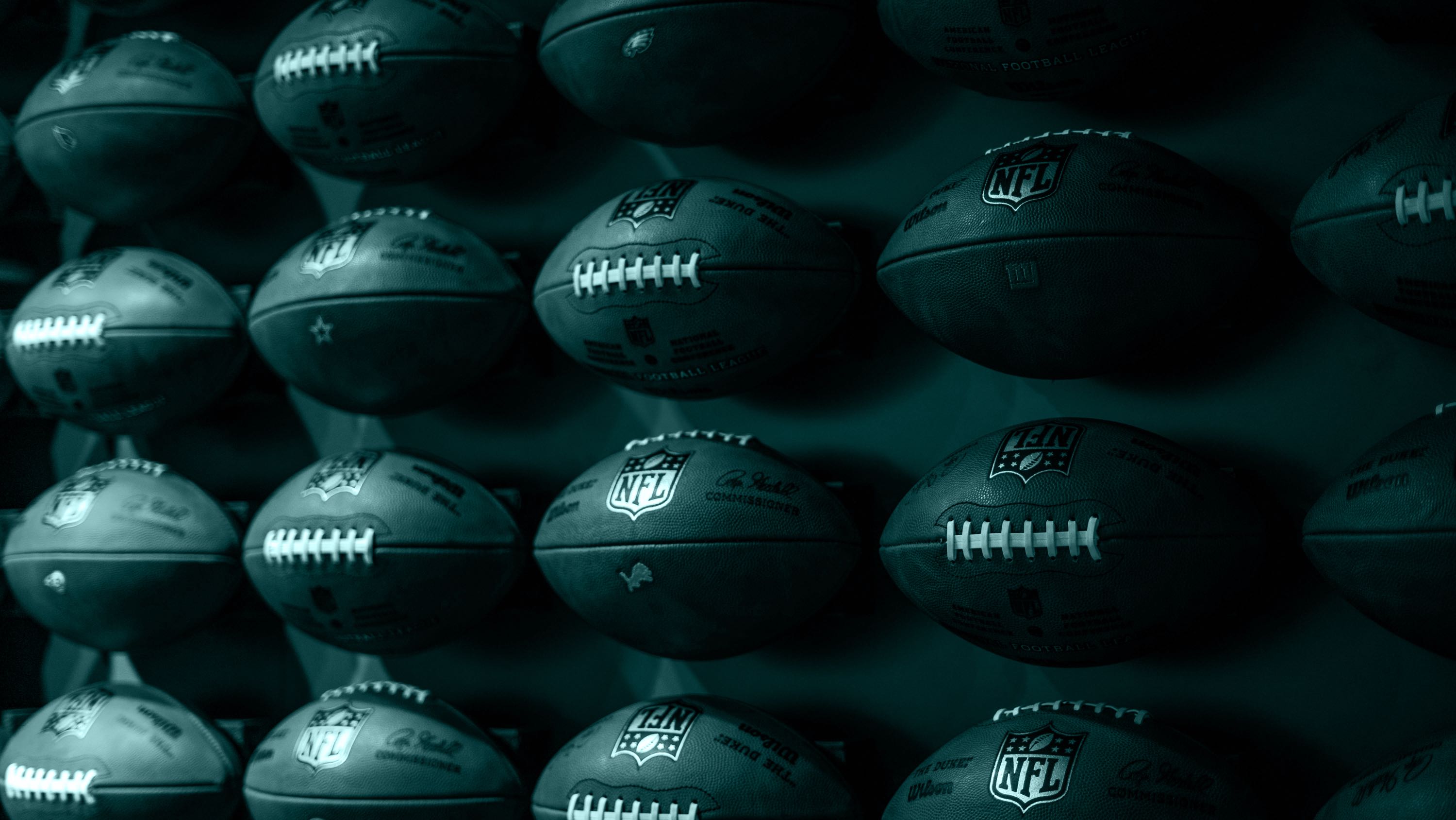 A photo of footballs hanging in the air